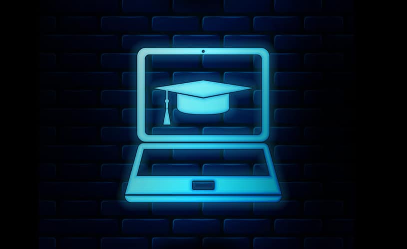 Virtual computer and graduation cap on blue and black brick wall representing Actian Academy