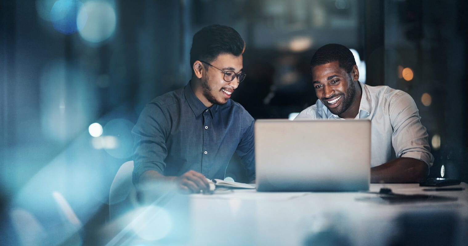 Two colleagues analyzing data on a laptop, illustrating the concept of Online Analytical Processing.